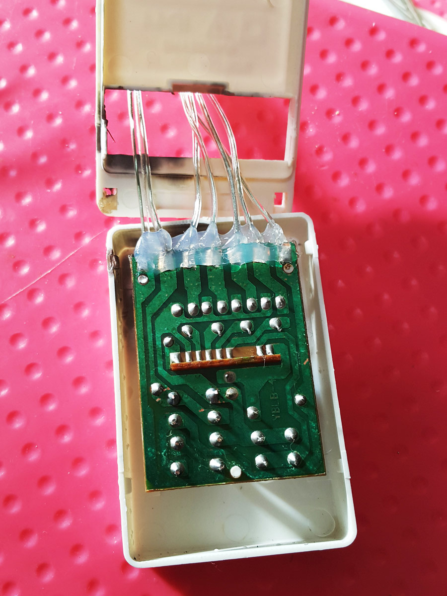 The two halves of the plastic housing showing broken plastic tabs/clips.