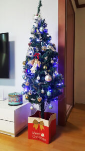 The fully decorated Christmas tree, illuminated by the repaired lights.