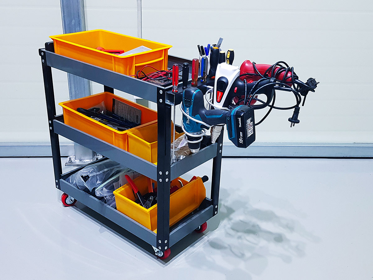 Drills and heat guns hanging neatly on the side.