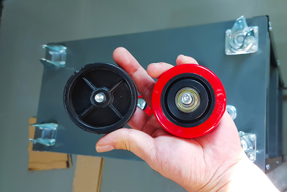A comparison: The old, hard plastic wheel vs. the new, soft rubber wheel with bearings.