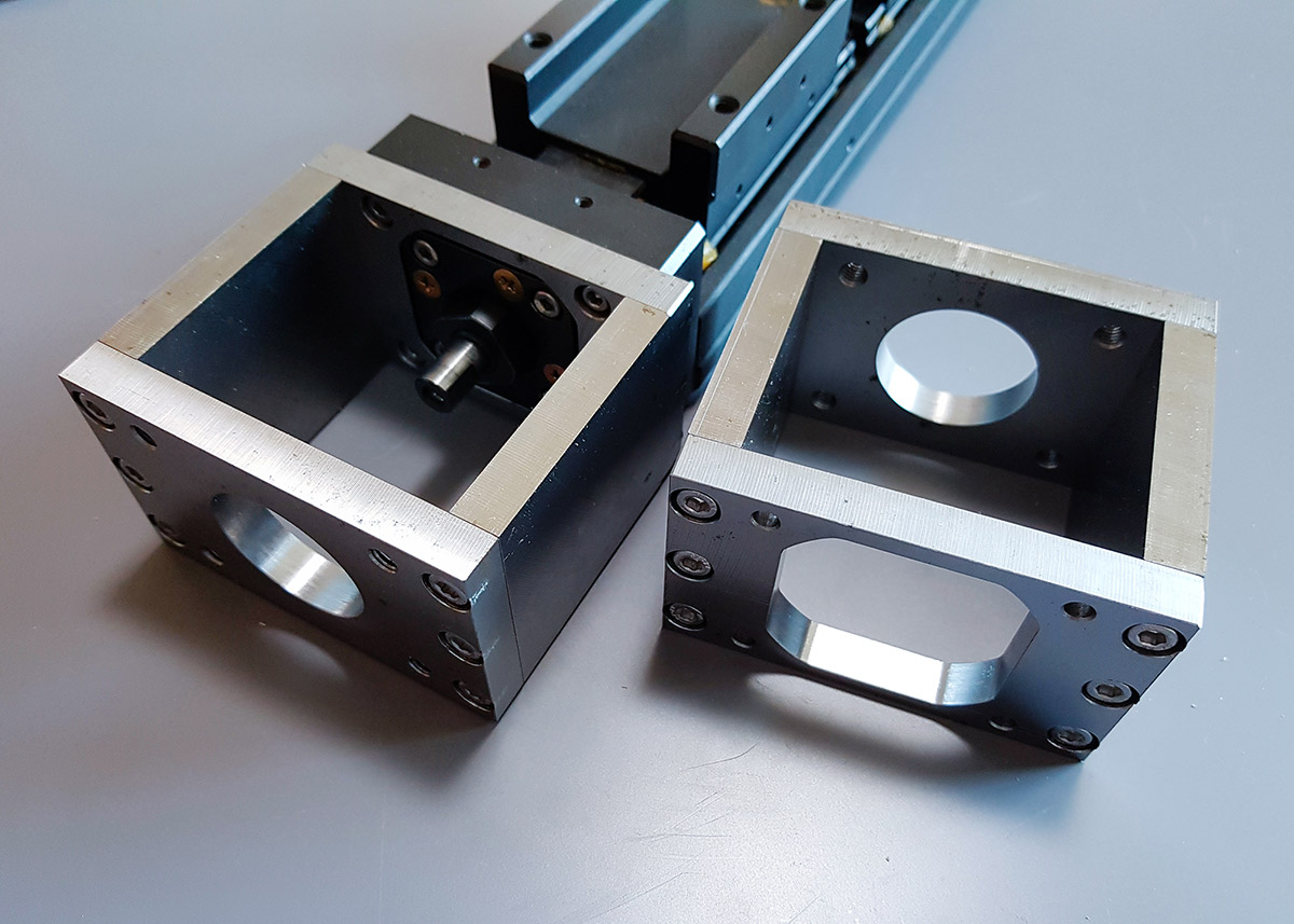 The final machined S45C steel mount bracket perfectly mounted on the NSK actuator.