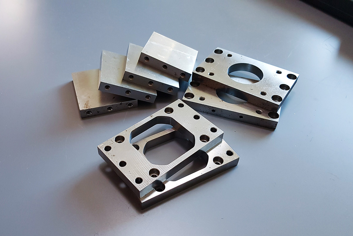 Finished S45C components after tapping and post-processing.