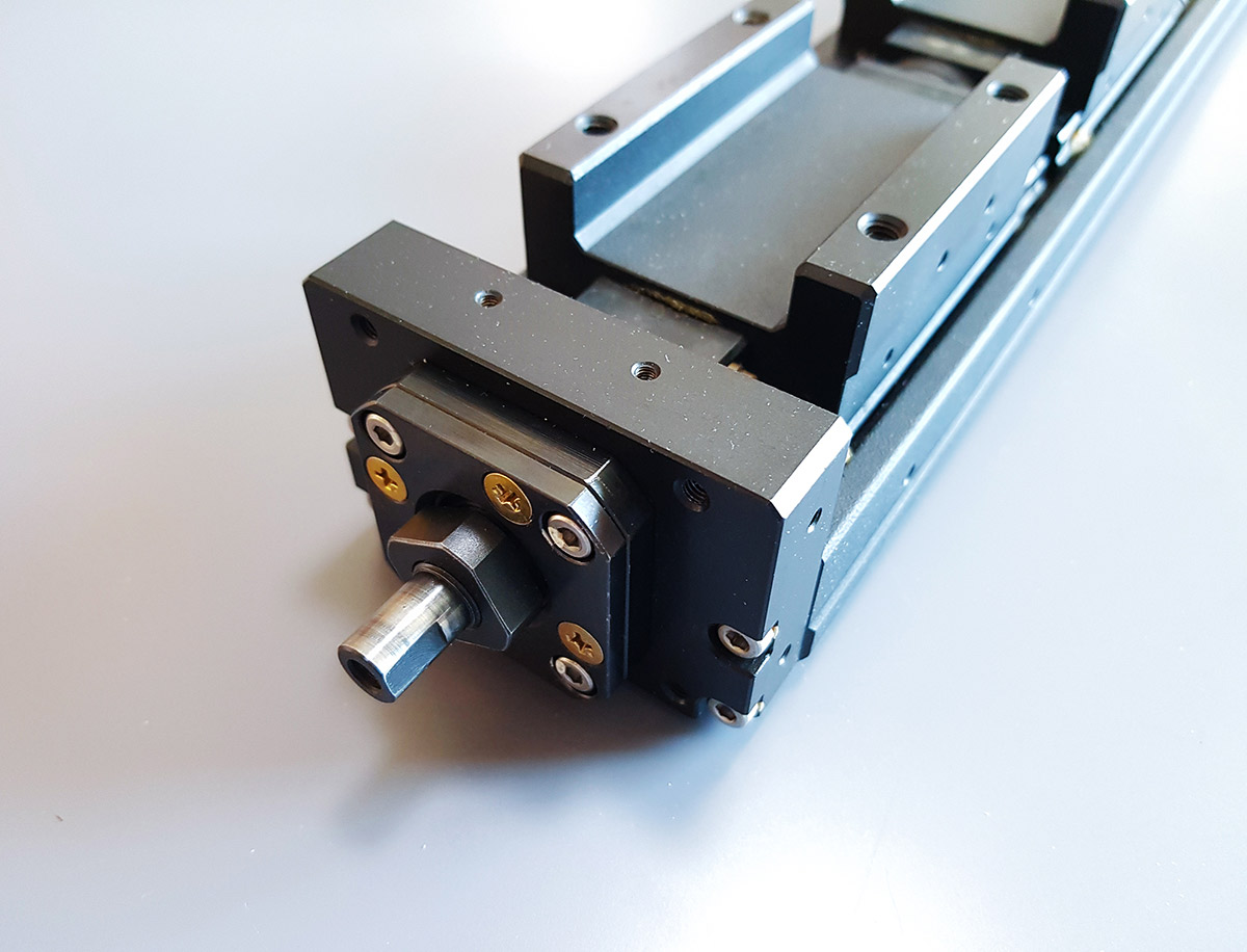 The NSK actuator without a motor mount, showing the protruding support unit that makes standard brackets unusable.