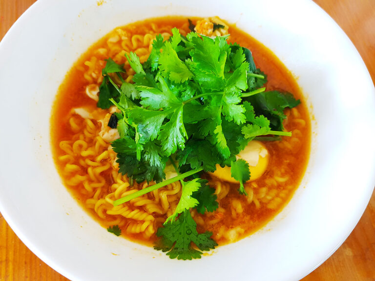 A bowl of instant ramen topped with freshly harvested coriander.